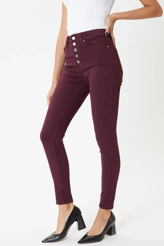Woman wearing high-waisted burgundy skinny jeans and black heels from Love Classic