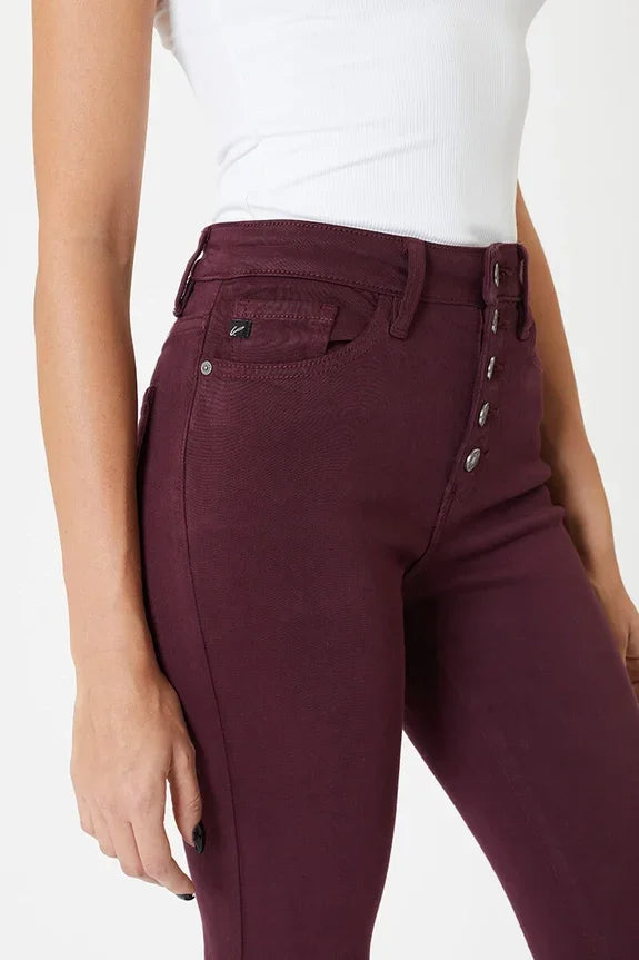 Woman in high waisted burgundy skinny jeans and white ribbed tank from Love Classic