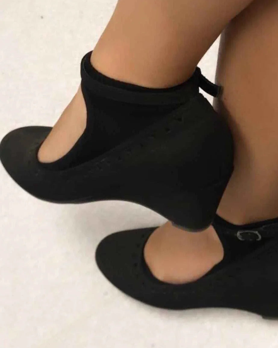Black ankle strap wedge shoes on feet, classic style from Love Classic