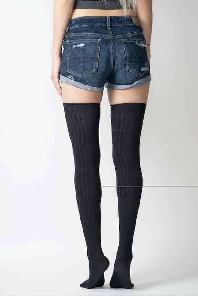 Woman in distressed denim shorts and black over-the-knee socks, Love Classic fashion
