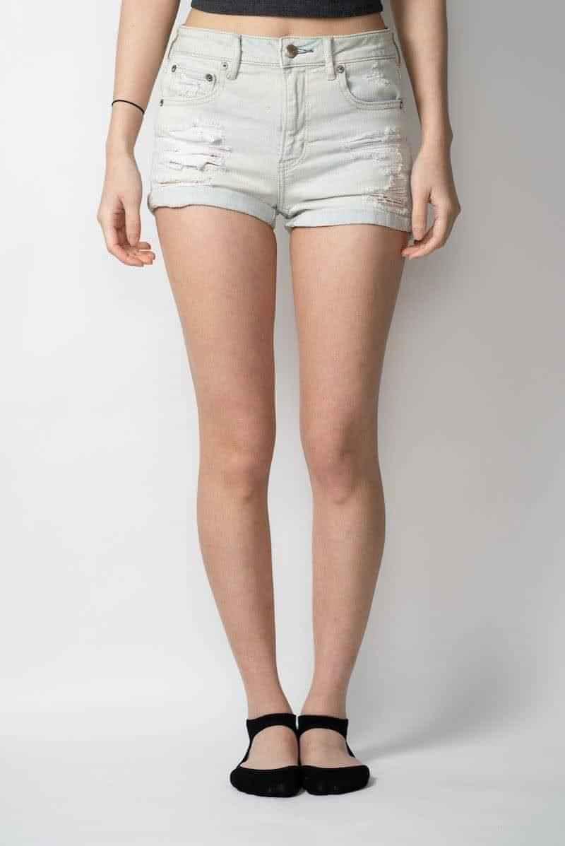 Light wash distressed denim shorts from Love Classic, front view on model