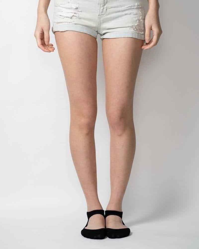 Light wash distressed denim shorts from Love Classic, front view on model