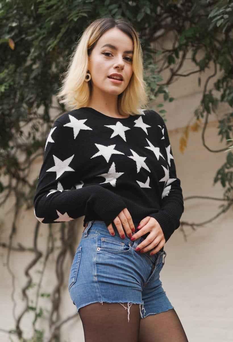 Woman in black star sweater and denim shorts outdoors, Love Classic high quality style