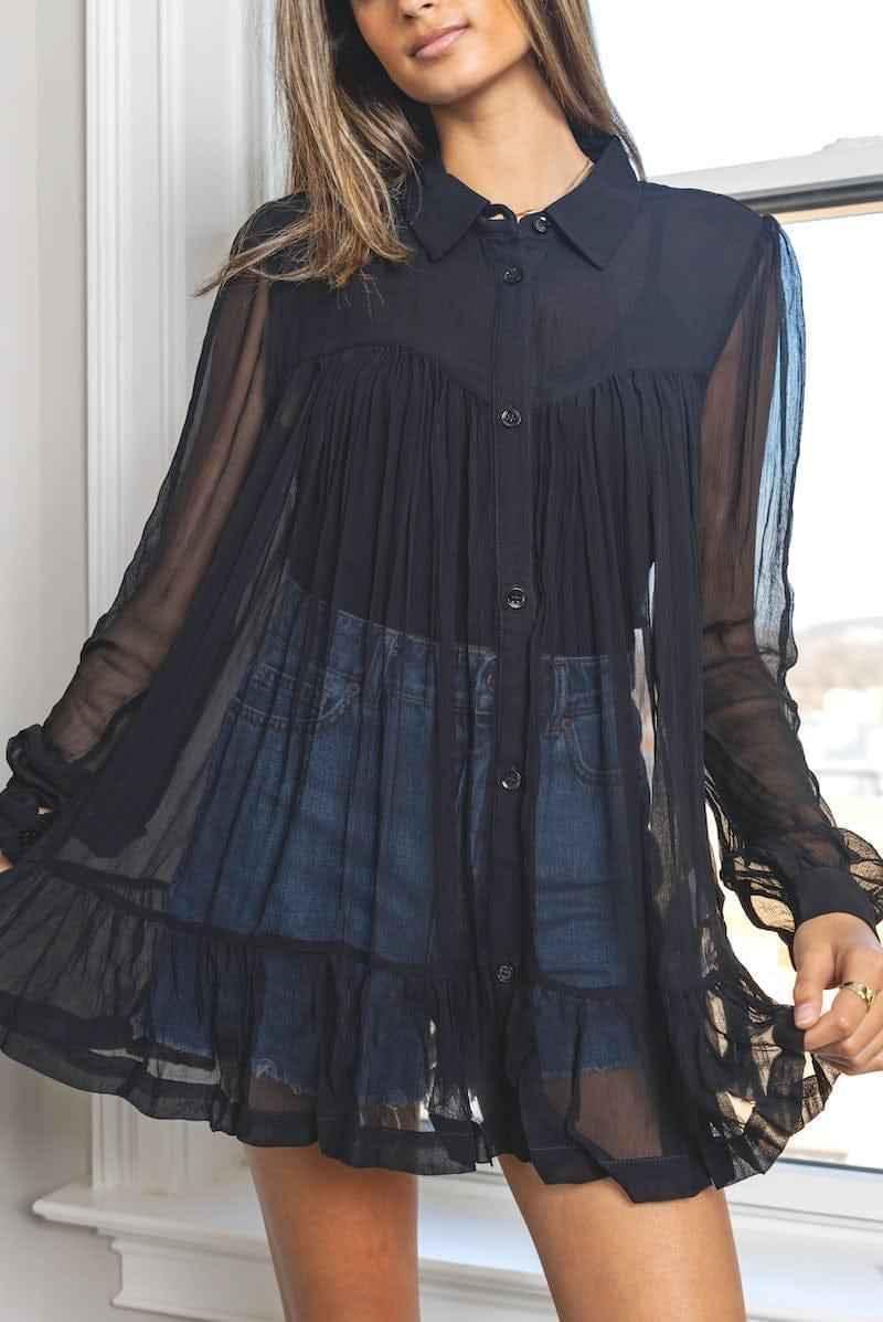 Woman wearing sheer black button-up blouse with denim shorts, Love Classic fashion style