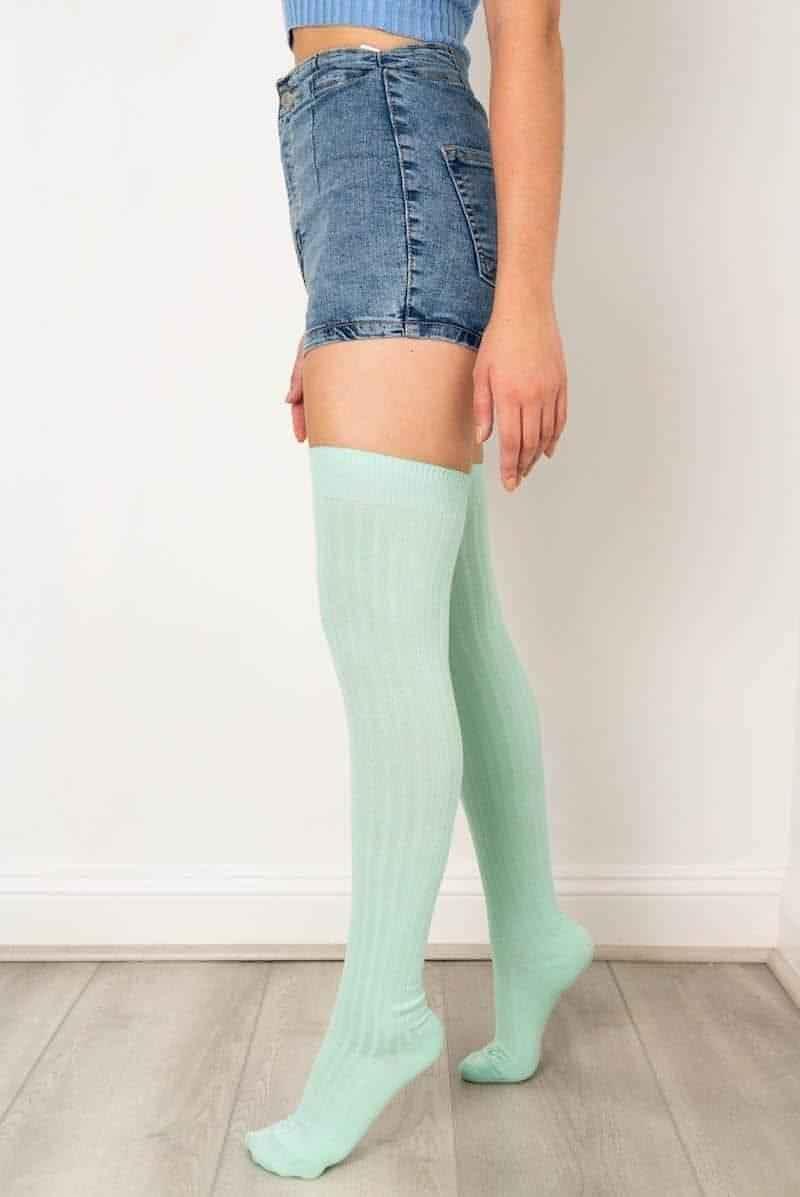 Woman wearing mint green thigh-high socks and denim shorts, Love Classic fashion style