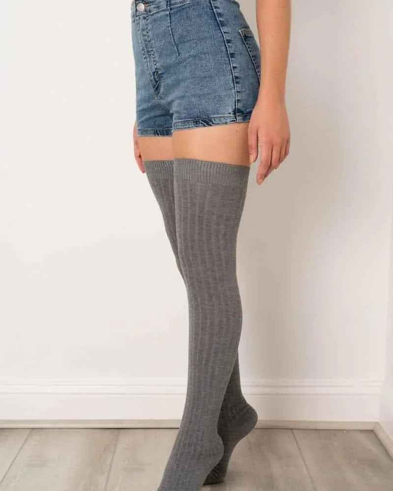 Woman in blue crop top, denim shorts, and gray over-the-knee socks from Love Classic