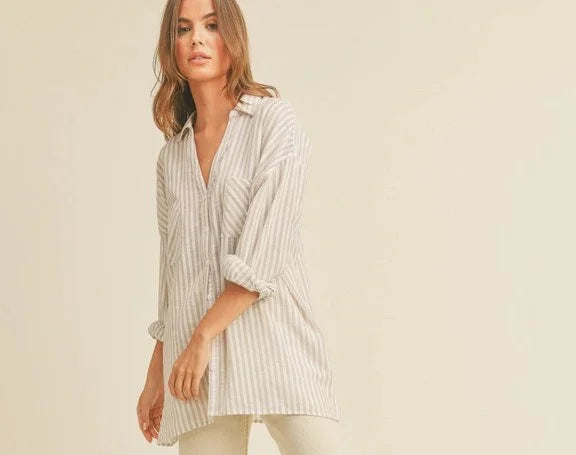 Woman wearing a loose striped shirt from Love Classic, showcasing casual high quality style.