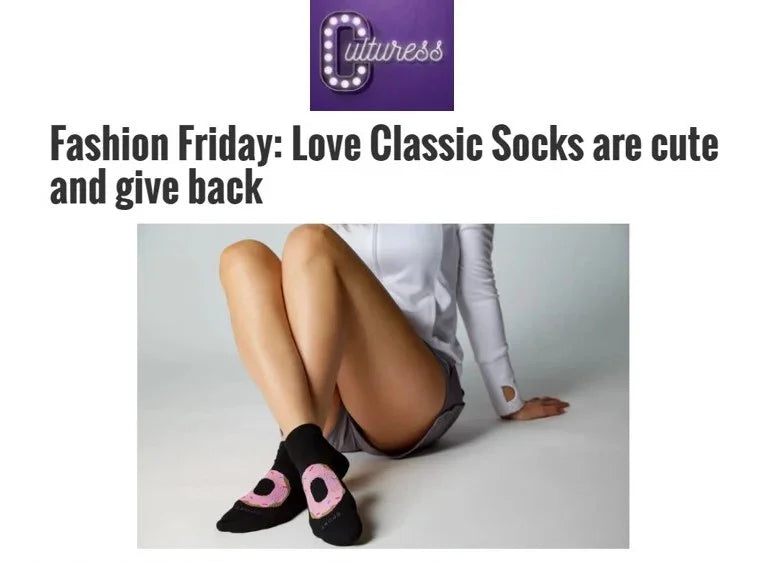 Woman wearing black and pink Love Classic socks, sitting on floor, stylish and cute fashion.