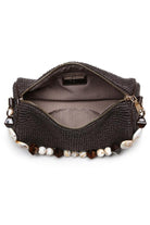 Interior of the chocolate Rachel Straw Clutch showing compact storage space designed to fit phone, cards, and small essentials.