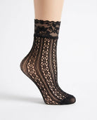 3-Pack Floral Diamond Lace Fishnet Socks featuring an elegant black openwork fishnet design with vertical diamond detailing and a delicate floral lace cuff, worn with white sneakers during an outdoor city stroll, highlighting breathable comfort, lightweight construction, and fashionable everyday styling.