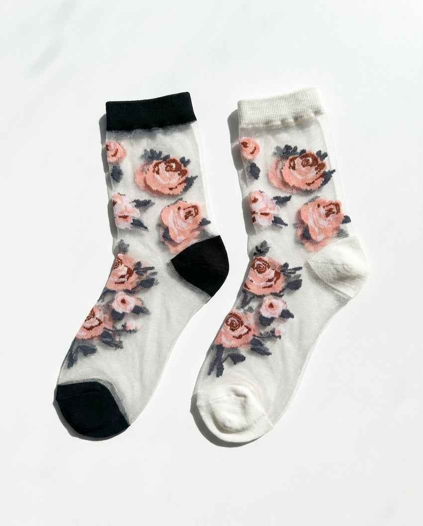 Roses Sheer Socks 2-Pack featuring two sheer ankle socks with embroidered rose motifs, contrasting cuff and toe panels, displayed flat on a bright studio background, highlighting the translucent finish and floral detailing.
