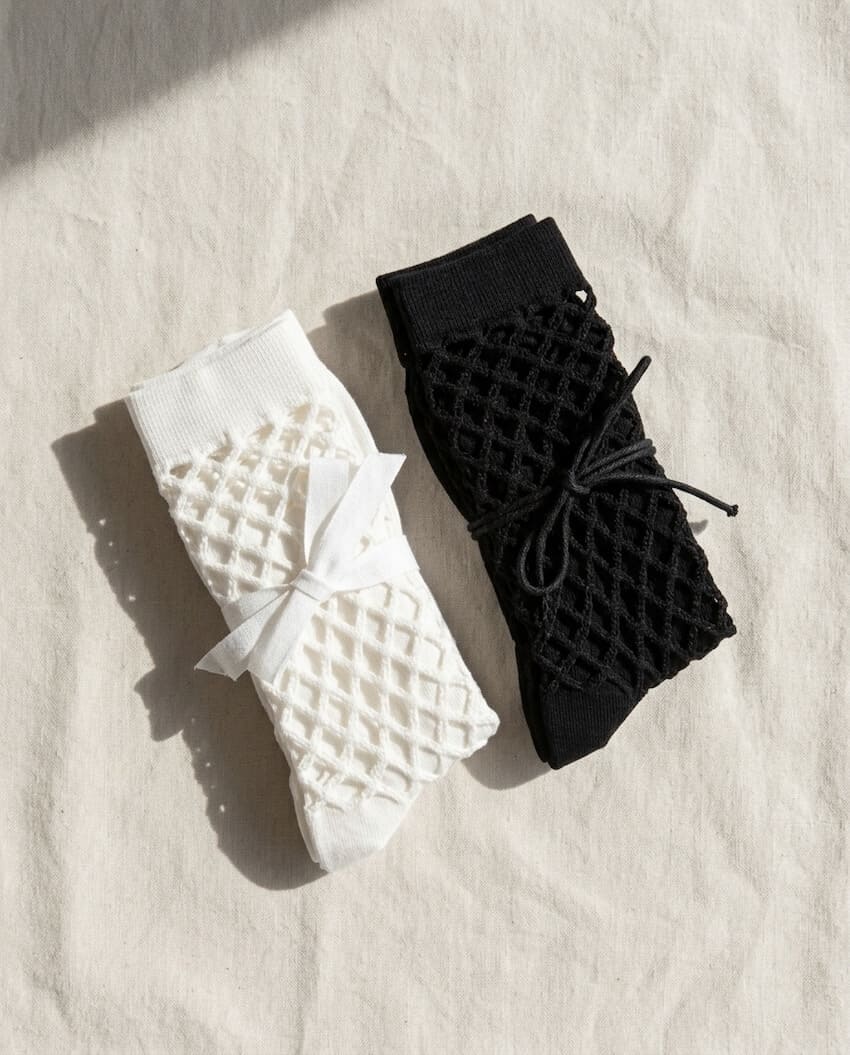 Bundled Pack, Midnight Lattice Fishnet Socks featuring breathable open mesh construction with a flexible crew fit and soft stretch comfort, worn in a lavender color variation beside a poolside setting with casual sneakers, highlighting lightweight comfort and relaxed seasonal styling.