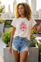 High Rise Distressed Denim Shorts featuring a high rise cut with ripped details and frayed edges, styled on a rooftop setting with city views, highlighting the flattering fit and laid back style.