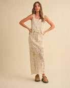Crochet Knitted Skirt featuring a sleeveless layered silhouette with intricate floral crochet patterns and an adjustable drawstring waist, styled with woven buckle sandals in a full front standing pose against a soft neutral studio backdrop, highlighting relaxed texture and flowing movement.