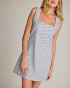 Dahlia Stripe Linen Dress, close-up front detail focusing on the square neckline, vertical stripe pattern, and smooth fitted bodice in a soft neutral setting.