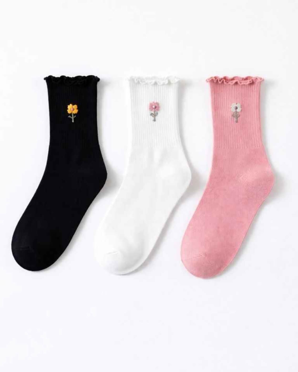 3-Pack Blush Pearl Rose Ruffle Crew Socks featuring three assorted ribbed crew socks with ruffled cuffs and delicate flower embroidery accents, arranged flat against a clean studio background, highlighting soft texture, everyday comfort, and charming styling variety.
