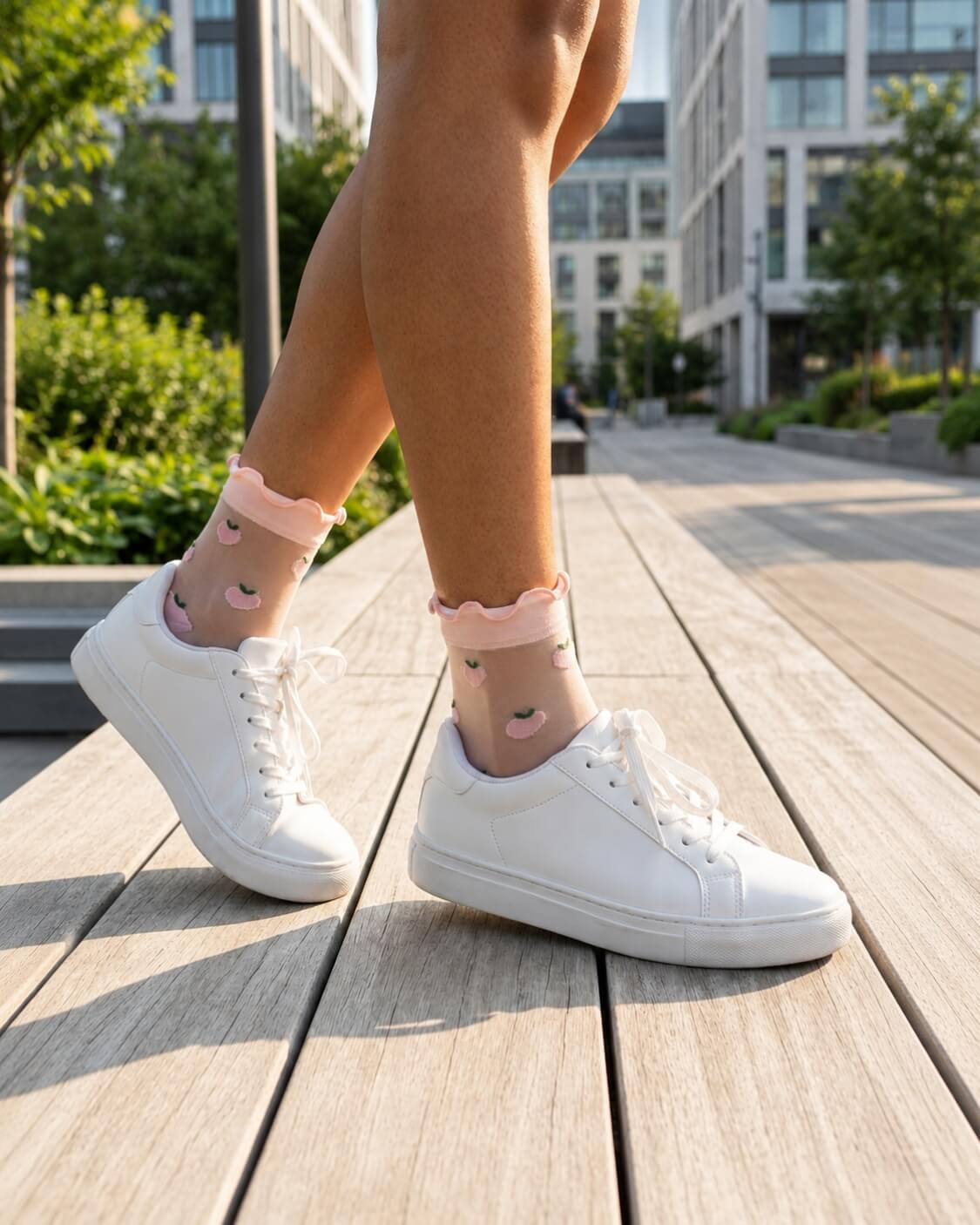 Whimsical Ruffle Edge Sheer Socks featuring a transparent ankle-length silhouette with delicate ruffle trim and playful peach motifs, worn with white lace-up sneakers while walking along a sunlit urban boardwalk, highlighting lightweight comfort and charming everyday styling.