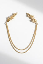 Bloom Bouquets Hair Chain featuring a delicate gold-tone hair accessory with leafy branch combs at each end, accented by small pearl-like details and connected by double draped chains, displayed on a clean white background to highlight its romantic, vintage-inspired elegance.