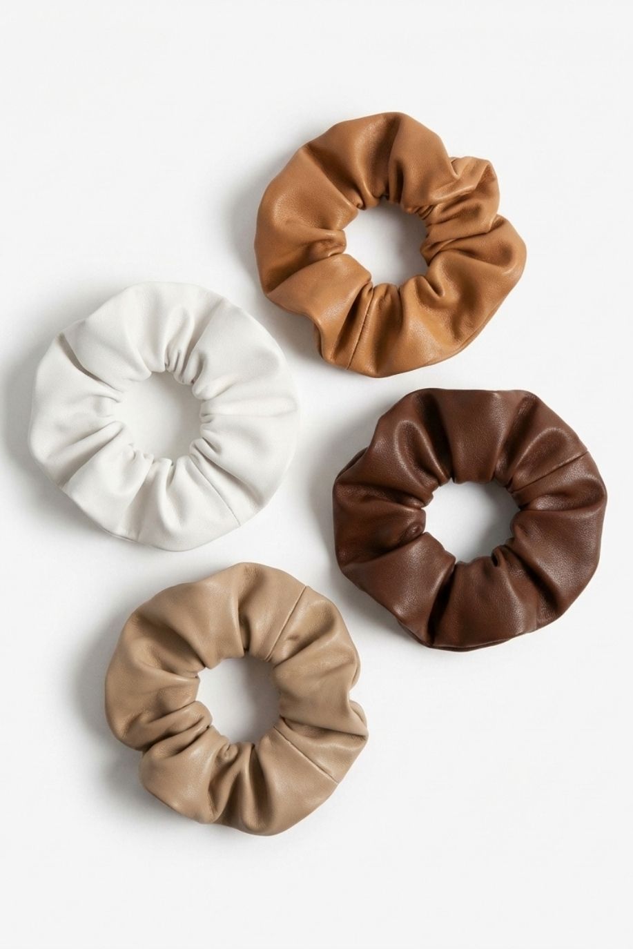 Western Faux Leather Scrunchies (Set of 4) in neutral tones including tan, ivory, beige, and deep brown, featuring a soft gathered design, arranged neatly on a clean white background.