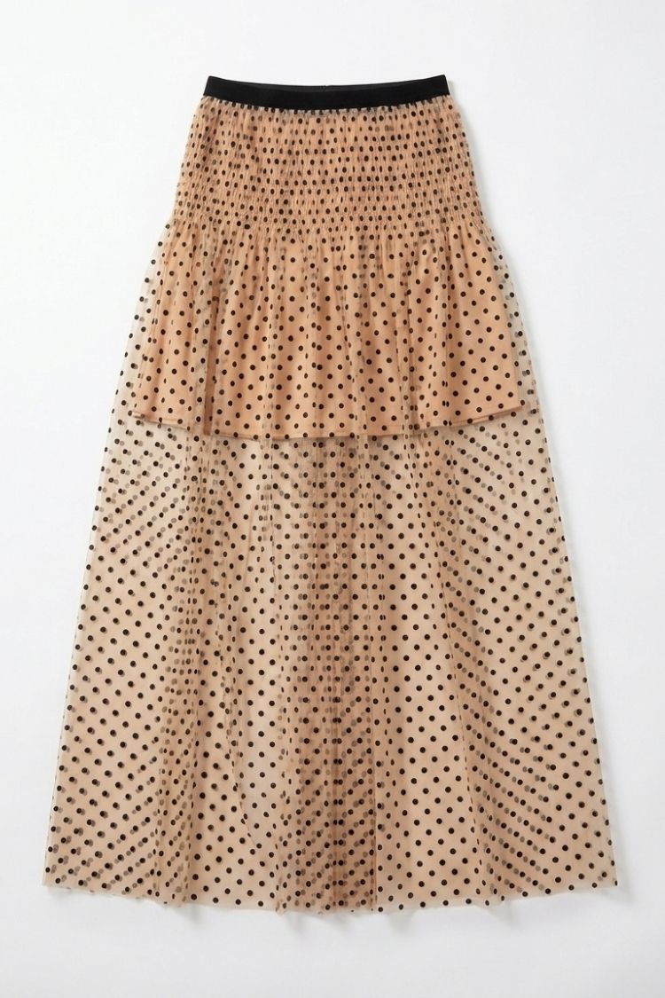 Mia Skirt, high-waist midi skirt in nude mesh with black polka dots and a smocked elastic waistband, shown in a flat lay front view against a neutral background, highlighting the layered design and soft, voluminous shape.
