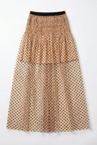 Mia Skirt, high-waist midi skirt in nude mesh with black polka dots and a smocked elastic waistband, shown in a flat lay front view against a neutral background, highlighting the layered design and soft, voluminous shape.