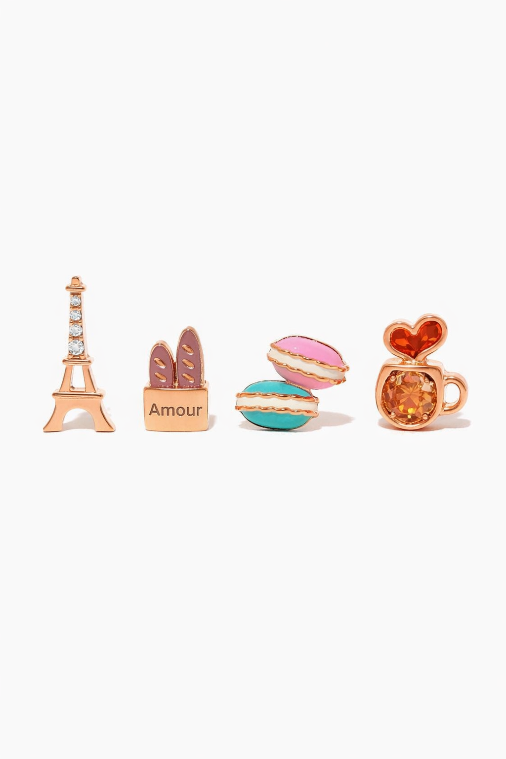 Café de Paris Stud Set, front product view showing Eiffel Tower, baguette bag, stacked macarons, and coffee cup studs in a polished gold tone with colorful enamel details.