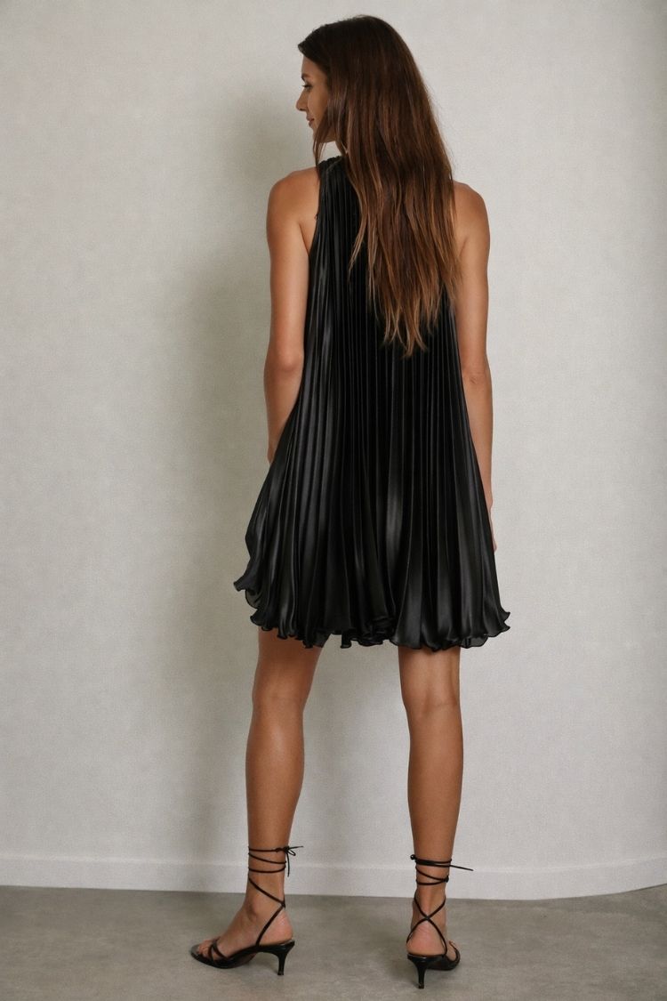 Woman in black pleated mini dress and strappy heels, Love Classic fashion style