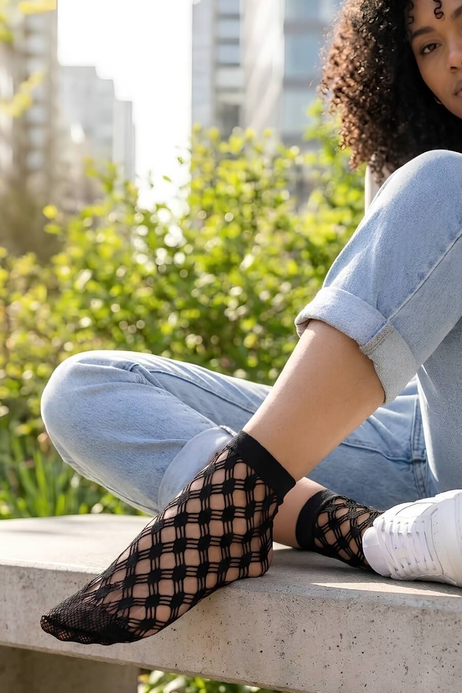 Honeycomb Lace Fishnet Socks featuring a bold honeycomb fishnet structure with comfortable ankle coverage, styled with rolled jeans and sneakers on outdoor steps to showcase lightweight texture and casual versatility.