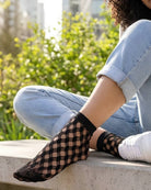 Honeycomb Lace Fishnet Socks featuring a bold honeycomb fishnet structure with comfortable ankle coverage, styled with rolled jeans and sneakers on outdoor steps to showcase lightweight texture and casual versatility.