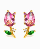 Blossoming Tulip Studs featuring pink teardrop crystal tulip detailing with green leaf accents and sparkling stone embellishments, displayed on a clean neutral backdrop, highlighting floral inspired styling and polished metallic finishing.