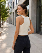 Shaper Fit Ribbed Knit Racerback Tank Top featuring a sleek racerback silhouette with soft ribbed stretch texture and clean trim detailing, shown from the back with a fitted shape and cropped length during a relaxed city stroll, highlighting flexible comfort and contouring support.
