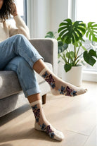 Butterfly Sheer Socks 2-Pack featuring soft sheer fabric with vibrant butterfly embroidery, styled in a cream color with casual denim in a sunlit indoor setting.
