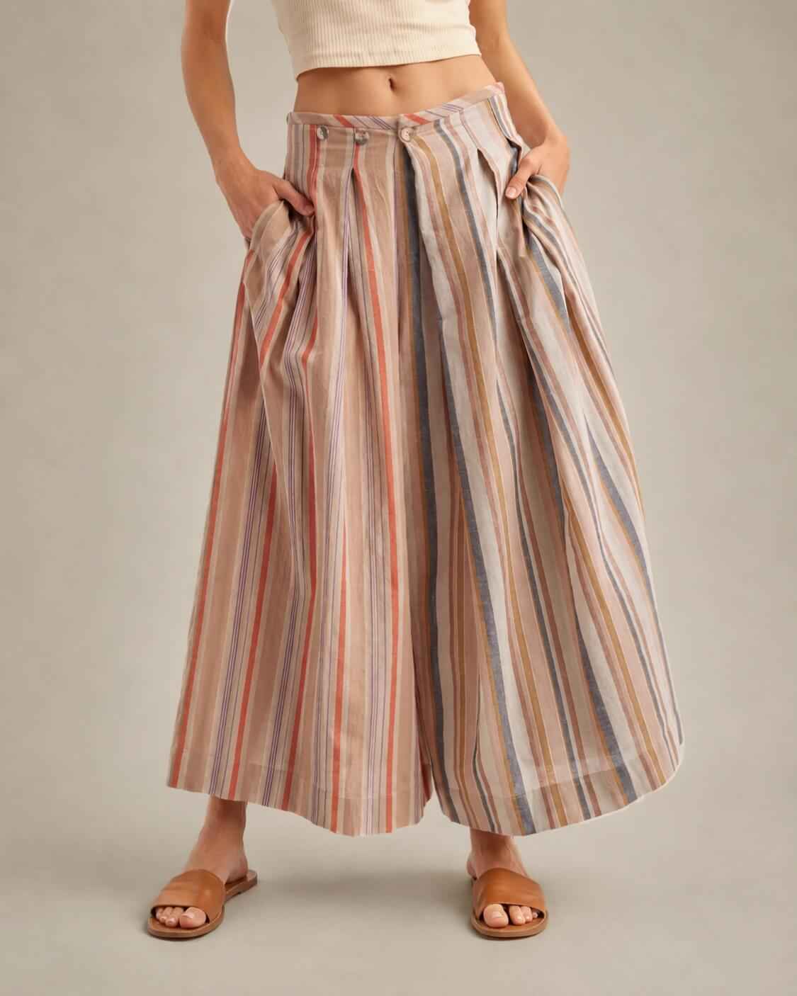 Multi-Stripe Pleated Front Wide-Leg Pants featuring deep side pockets with a pleated front waist and earthy-toned stripe pattern, worn with a fitted cropped tank during a casual standing pose indoors, highlighting the airy fit and laid-back styling.