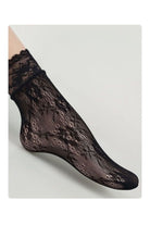 Black sheer floral lace mesh ankle socks with a scalloped lace cuff, shown on a model against a light background.