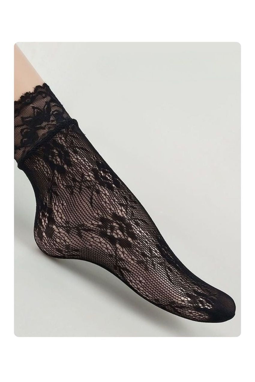Black sheer floral lace mesh ankle socks with a scalloped lace cuff, shown on a model against a light background.