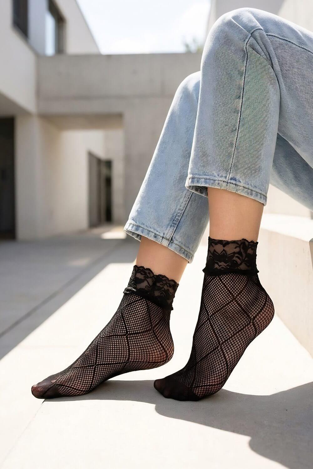 Diamond Lace Fishnet Socks featuring a lightweight mesh construction with geometric diamond accents and scalloped lace trim, worn with cuffed denim in a modern outdoor setting with soft natural lighting that highlights the intricate texture and feminine finish.