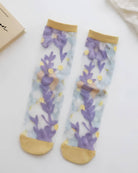 Floral Pattern Sheer Socks 4-Pack featuring purple and yellow floral artwork on sheer mesh fabric with gold-toned cuffs and toe panels, displayed as a matching pair on a bright white background, highlighting airy texture and colorful feminine detail.