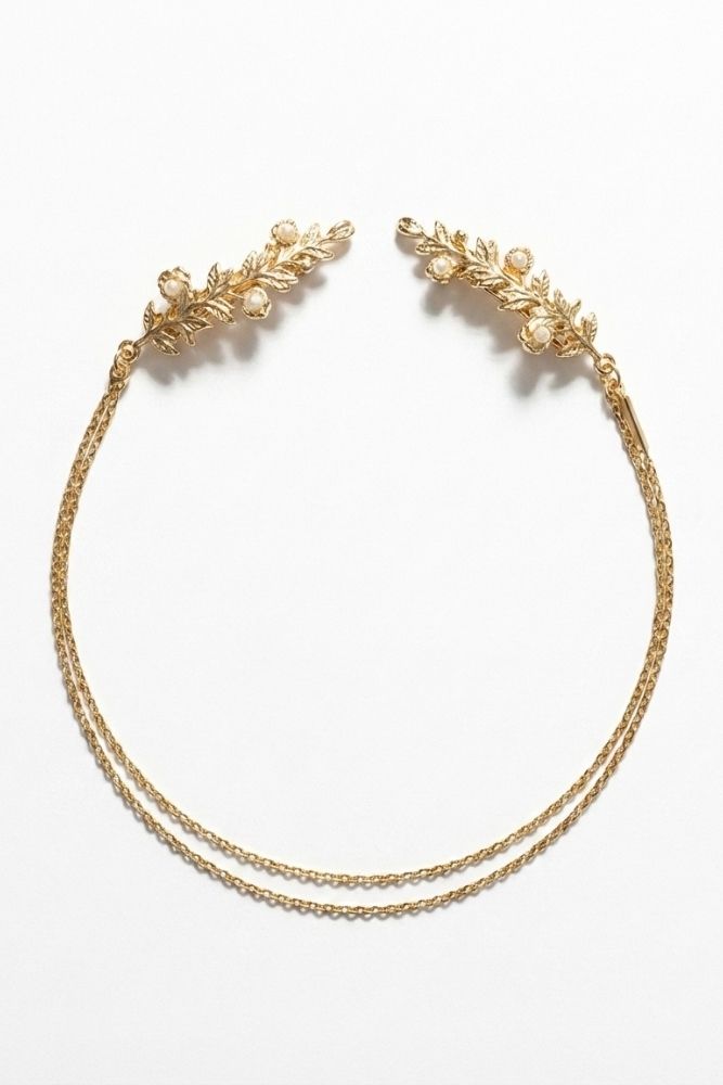 Bloom Bouquets Hair Chain showcasing a gold floral hair chain with ornate leaf combs and pearl-inspired accents, joined by two fine chains in a graceful curved arrangement on a minimal backdrop, emphasizing its bridal charm and refined decorative detail.