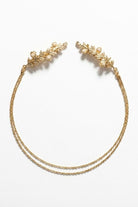 Bloom Bouquets Hair Chain showcasing a gold floral hair chain with ornate leaf combs and pearl-inspired accents, joined by two fine chains in a graceful curved arrangement on a minimal backdrop, emphasizing its bridal charm and refined decorative detail.