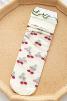 Sheer mesh crew socks with a cherry pattern and a soft lettuce-edge cuff on a neutral background.