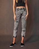 Woman wearing high-waisted acid wash jeans and black crop top, Love Classic fashion style