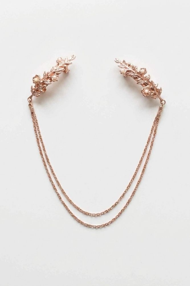 Bloom Bouquets Hair Chain featuring a rose gold-tone design with intricate leafy combs, petite pearl-like embellishments, and double cascading chains, displayed flat on a neutral background to highlight its soft shimmer and feminine, ethereal style.