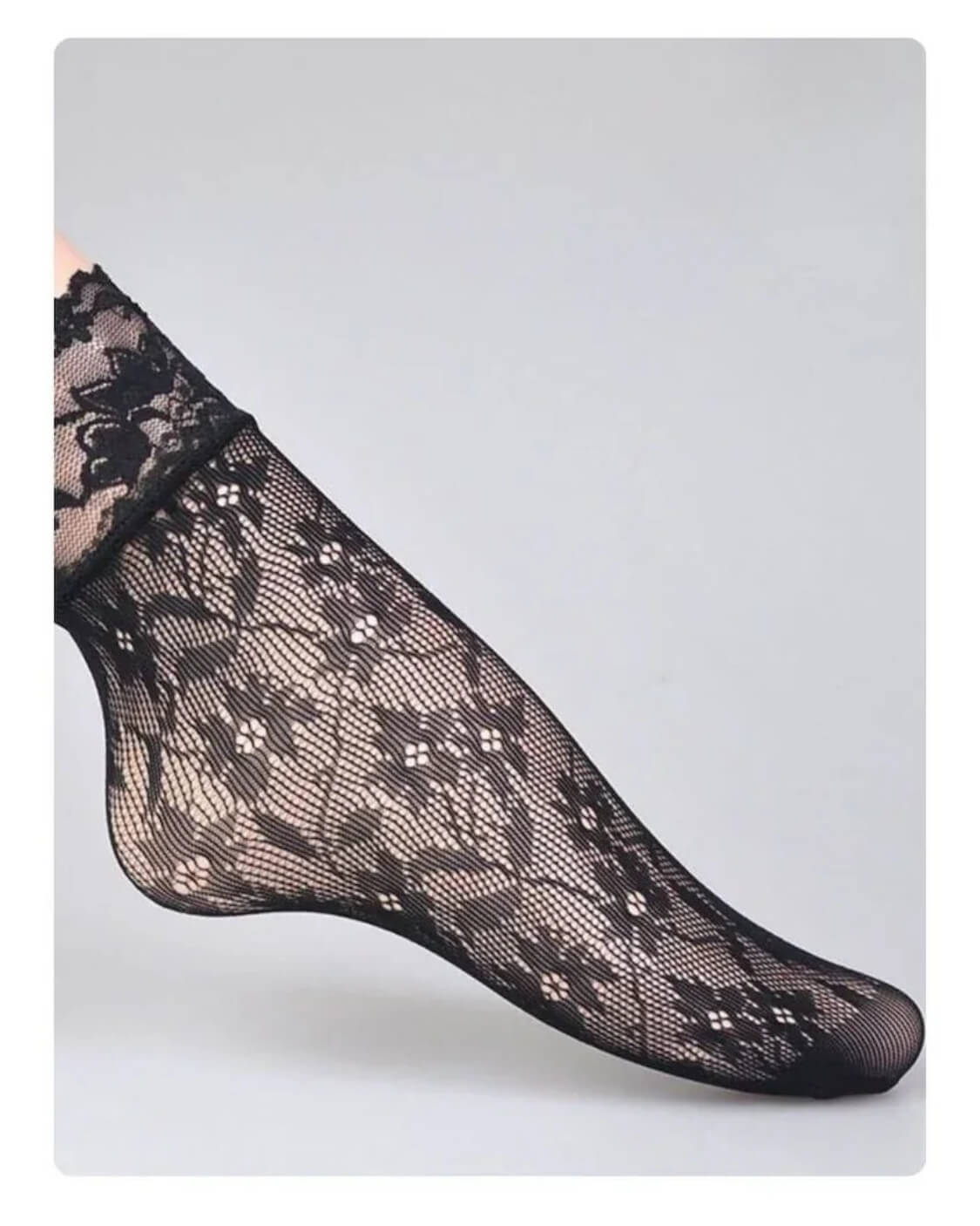 3-Pack Romantic Floral Fishnet Socks featuring sheer black mesh with floral lace patterns and a scalloped ankle cuff, shown in a side foot pose against a clean grey backdrop, highlighting delicate texture and feminine styling.