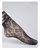 3-Pack Romantic Floral Fishnet Socks featuring sheer black mesh with floral lace patterns and a scalloped ankle cuff, shown in a side foot pose against a clean grey backdrop, highlighting delicate texture and feminine styling.
