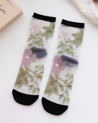Floral Pattern Sheer Socks 4-Pack featuring embroidered-style pink and white flowers with green leaf detailing on sheer mesh, finished with black cuffs and toe accents, highlighting elegant contrast and delicate garden-inspired styling.