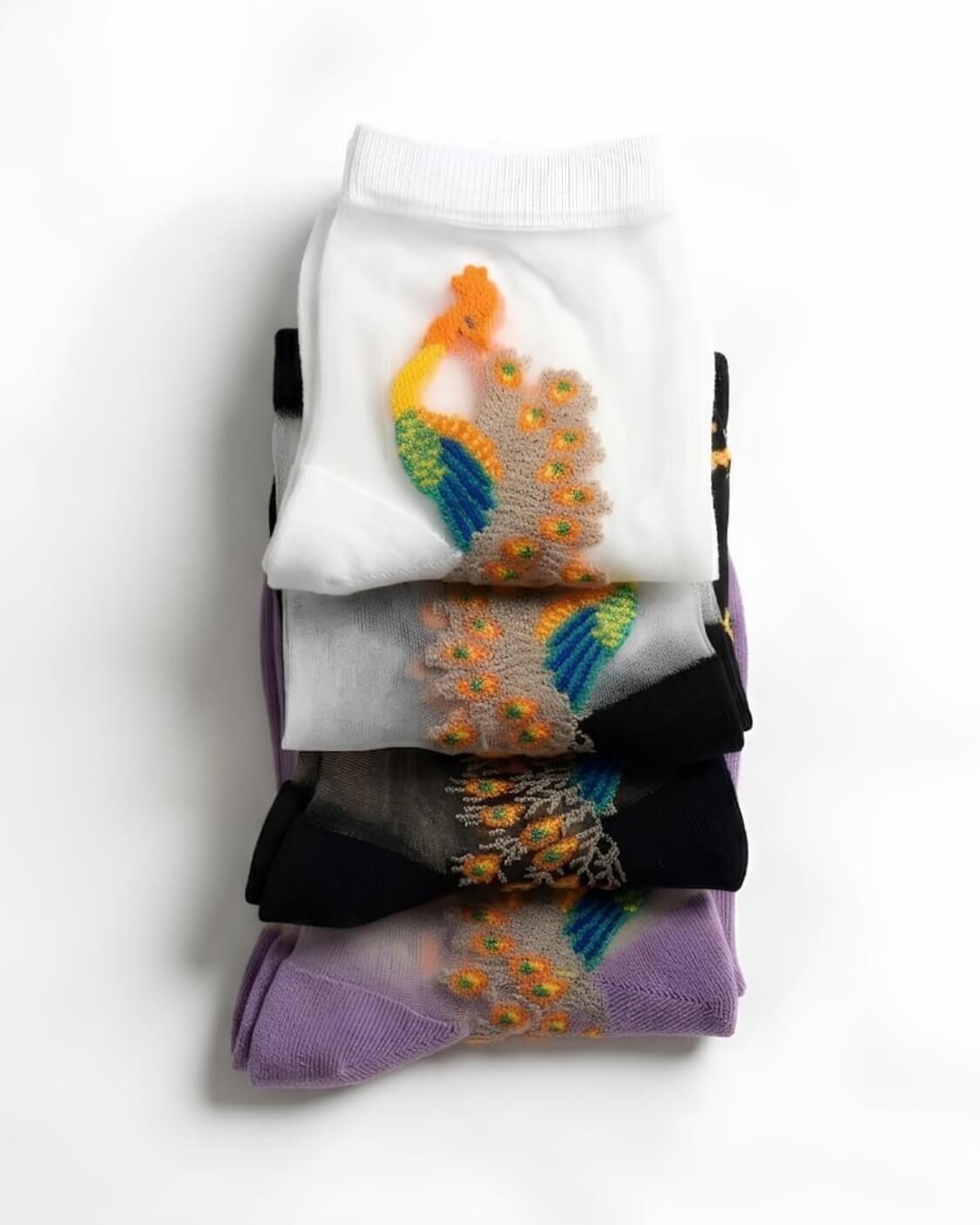 4-Pack Peacock Sheer Mesh Socks featuring sheer mesh construction with vibrant peacock embroidery and soft ribbed cuffs, stacked together in assorted color variations on a neutral backdrop, showcasing the delicate texture and playful artistic detailing.