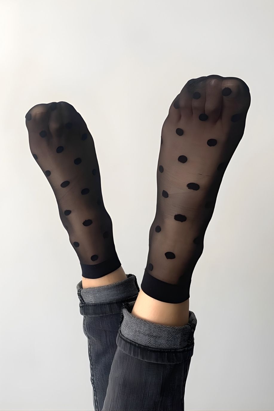 2-Pack Sheer Polka Dot Socks featuring a sheer black finish with bold polka dot pattern and smooth stretch fit, worn with legs lifted upward, emphasizing texture, pattern clarity, and a relaxed casual styling.