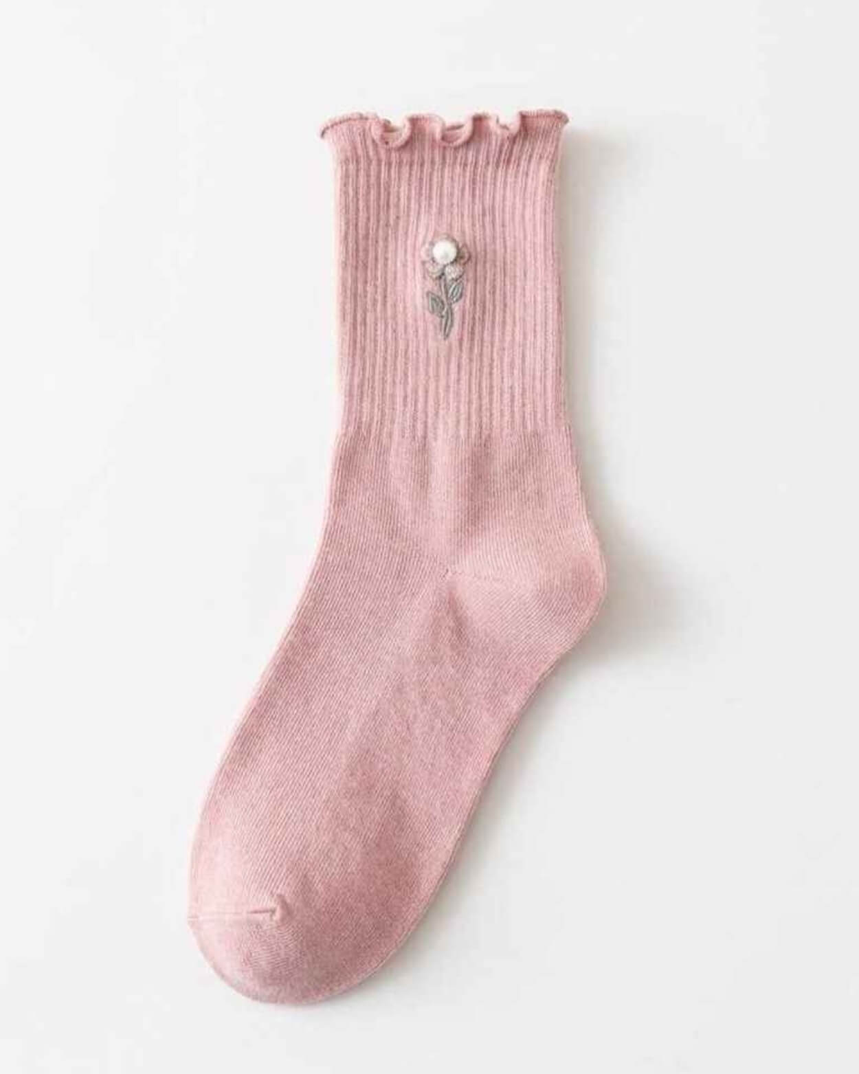 3-Pack Blush Pearl Rose Ruffle Crew Socks featuring a ribbed crew sock with a ruffled cuff, rounded toe, and delicate flower embroidery near the ankle, displayed flat against a clean studio background, highlighting soft texture and simple everyday styling.