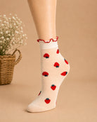 Whimsical Ruffle Edge Sheer Socks featuring a translucent ankle-length profile with strawberry motifs and a contrasting ruffle edge, displayed in a close-up studio setting to highlight the lightweight fabric, detailed pattern, and comfortable stretch fit.