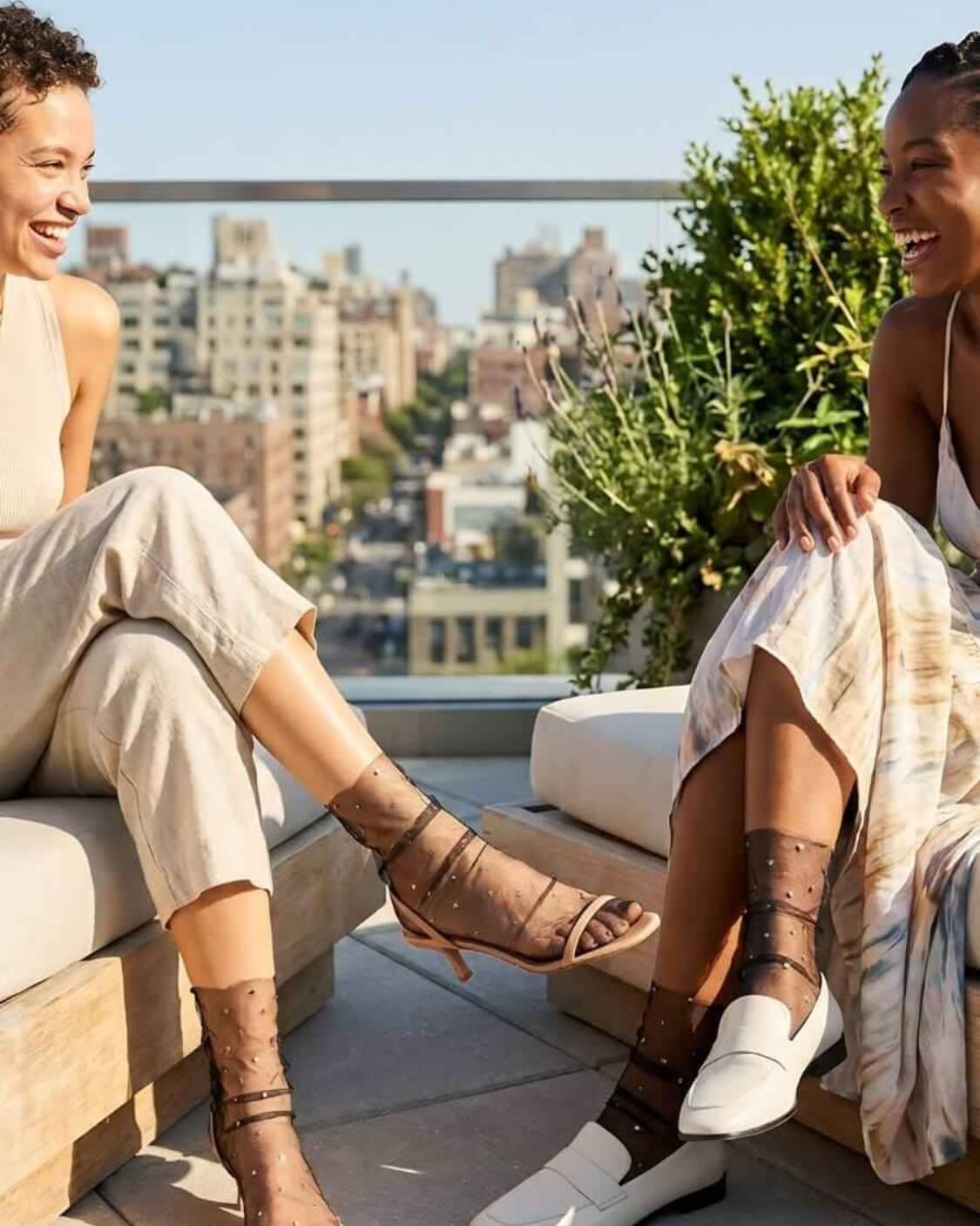 Star Soft Tulle Mesh Sheer Socks featuring soft transparent mesh with sparkling star embellishments and gathered detailing, worn with heels and loafers during a rooftop social setting, highlighting versatile styling for casual and dressy footwear.